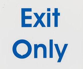 white exit only sign with blue letters