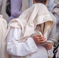 Wall Mural - Orthodox hassidic Jew pray in a holiday robe and tallith.