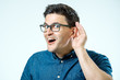 © Iurii - Head shot of man trying listen gossip or news. Isolated on grey background