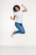© Drobot Dean - Full length portrait of a pretty joyful woman jumping