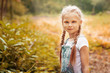 © svetabezu - Adorable smiling little blonde girl with braided hair. Cute child having fun on a sunny summer day outdoor.