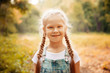 © svetabezu - Adorable smiling little blonde girl with braided hair. Cute child having fun on a sunny summer day outdoor.