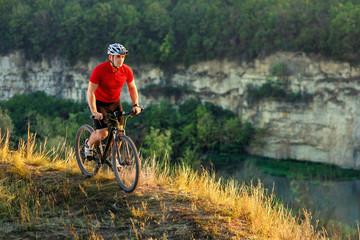 Wall Mural - Bike adventure travel photo. Cyclist on the Beautiful Meadow Trail on sunny day.