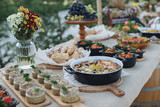 Fototapeta Miasto - Outdoors fourchette table with traditional moldavian appetizers and fresh flowers