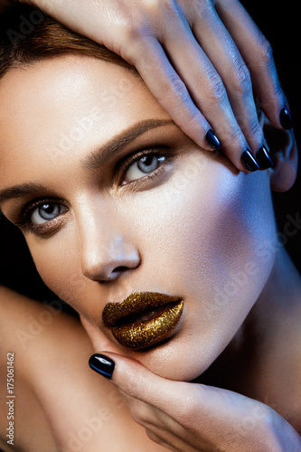 Poster Beautyful girl with gold glitter on her face and body