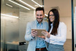 © NDABCREATIVITY - Attractive business couple using tablet in their company