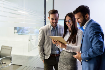 Wall Mural - Businessmen and businesswoman using tablet in office