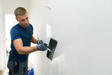 Fototapeta  - home improvement - construction worker with plastering tools renovating apartment walls