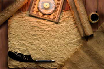 Wall Mural - vintage black quill pen and candle on old blank paper sheet