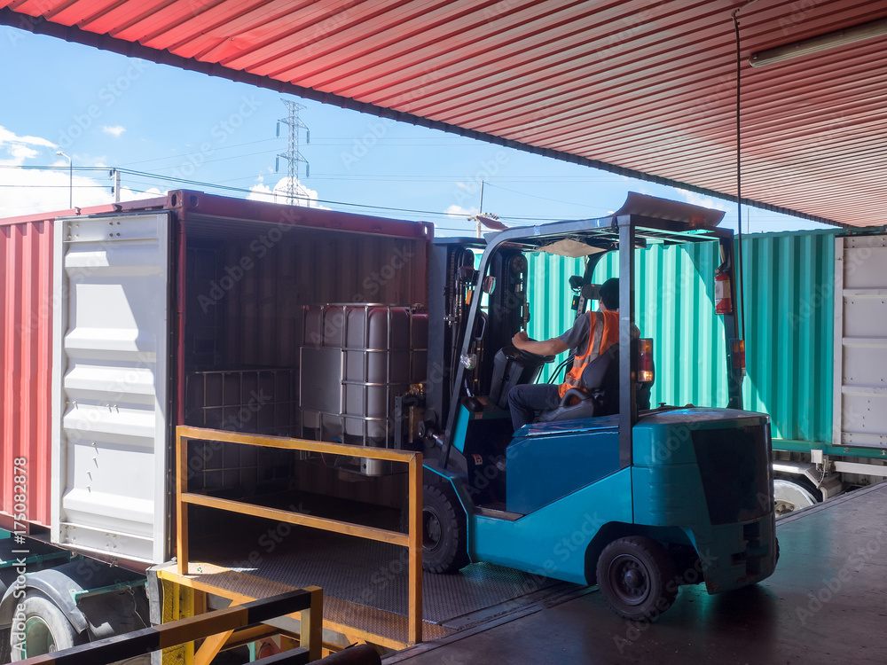 Forklift unstuffing tank of solvent from container to storange in ...