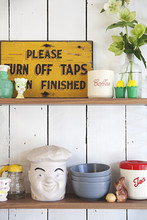 Shelves In A Kitchen With Fun Retro Items, Bowls And Canisters