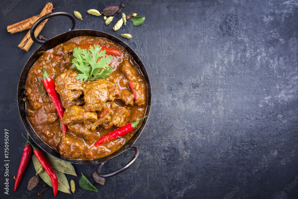 Traditional Indian curry lamb masala as close-up in a Korai with copy space right - obrazy, fototapety, plakaty 