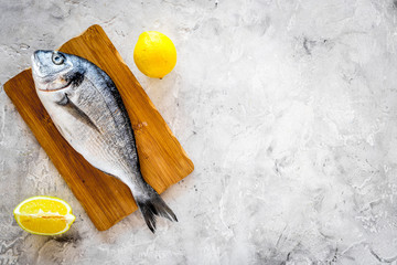 Fresh dorado fish ready to cook on grey background top view copyspace