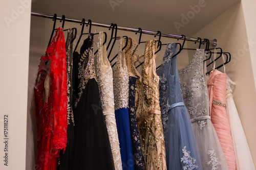 Many ladies evening gown long dresses on hanger in the dress Many ladies evening gown long dresses on hanger in the dress