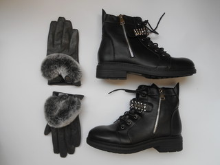 Women's boots, fur, grey gloves on the white background