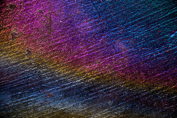 Rainbow oxidation texture on stone, macro science and nature background texture