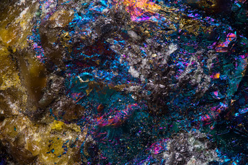 psychedelic rainbow colored stone texture, nature and science background.