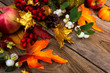 Thanksgiving background with golden maple leaves, rowan and white berries