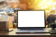 © noreefly - Laptop blank screen on desk in morning sunshine coffee shop