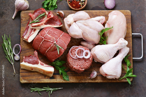 Fotomural raw meat assortment - beef, lamb, chicken on a wooden board