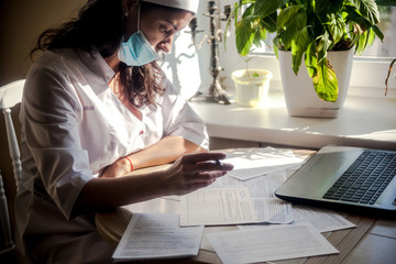 The doctor fills the patient's medical record