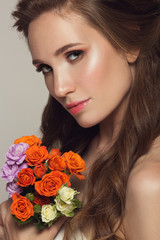 Wall Mural - Close up portrait of young beautiful woman with flowers.