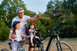 © Aleksey - Cheerful family biking in park