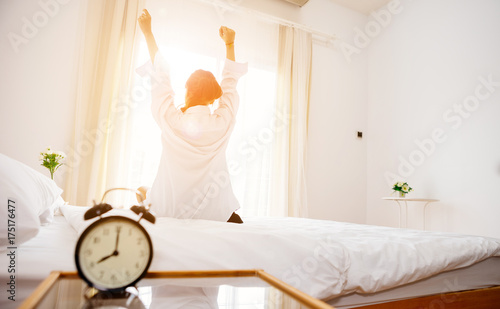 Alarm Clock Black Is Placed On A White Bed In Bedroom In