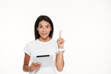 Sticker - Portrait of an excited smart woman holding tablet