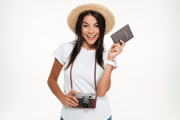 Sticker - Portrait of a happy young woman in hat holding camera