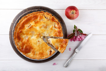 Wall Mural - Homemade creamy apple pie on white wooden table.