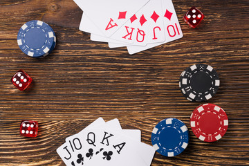 poker game on a wooden table, cards with chips and dice of poker