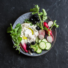 Wall Mural - Greek yogurt with vegetables. Healthy snack on dark background, top view