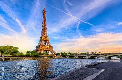 Plakat Wieża Eiffla w Paryżu i Sekwana o zachodzie słońca w Paryżu, Francja. Wieża Eiffla to jeden z najbardziej charakterystycznych punktów orientacyjnych Paryża.