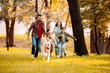 © LIGHTFIELD STUDIOS - family running after dog
