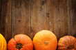 Pumpkins on wooden background. thanksgiving and halloween concept. Top view