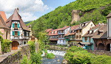 French Traditional Half-timbered Houses And La Weiss River In Kayserberg Village In Alsace, France
