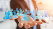 © sdecoret - Businessman holding 3D rendering group of blue people