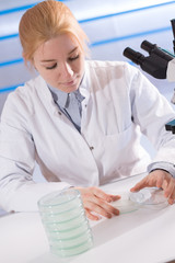 Poster - scientist woman holding petri dish