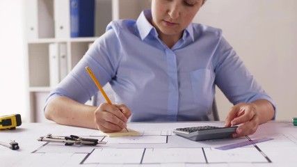 Canvas Print - female architect counting on calculator at office