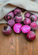 Chioggia striped or candy stripe beet whole and sliced in burlap sack on wooden table, selective focus