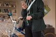 Mid section of woman with bicycle using phone