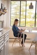 © Wavebreak Media - Woman sitting with baby while using digital tablet