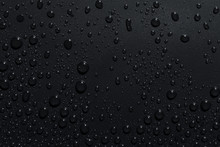 Closeup Of Black Raindrops On Dark Surface, Abstract Background