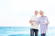 © Africa Studio - Happy senior couple walking at sea