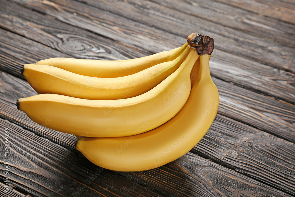 Yummy bananas on wooden background