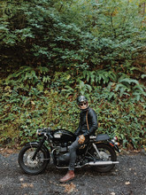 Man Sitting On A Motorcycle By The Forest