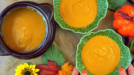 Halloween pumpkin soup with spider web sour cream decorations