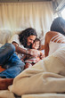 © Julien L. Balmer/Stocksy - Hippies on the Road - Father Caressing Son in Stylish Camper Van