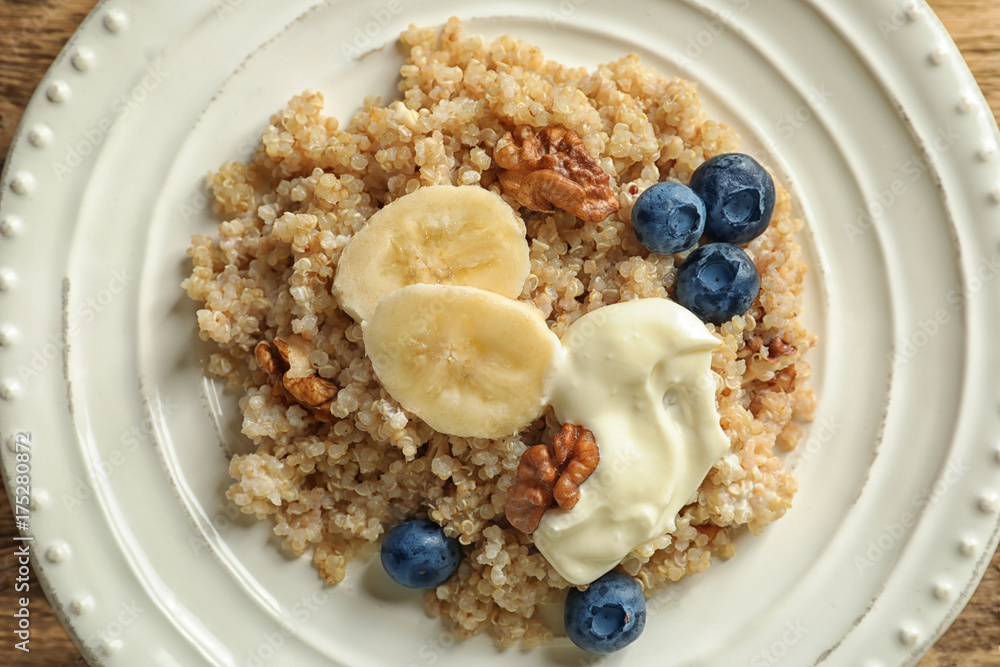Dessert with quinoa, banana and blueberries on plate